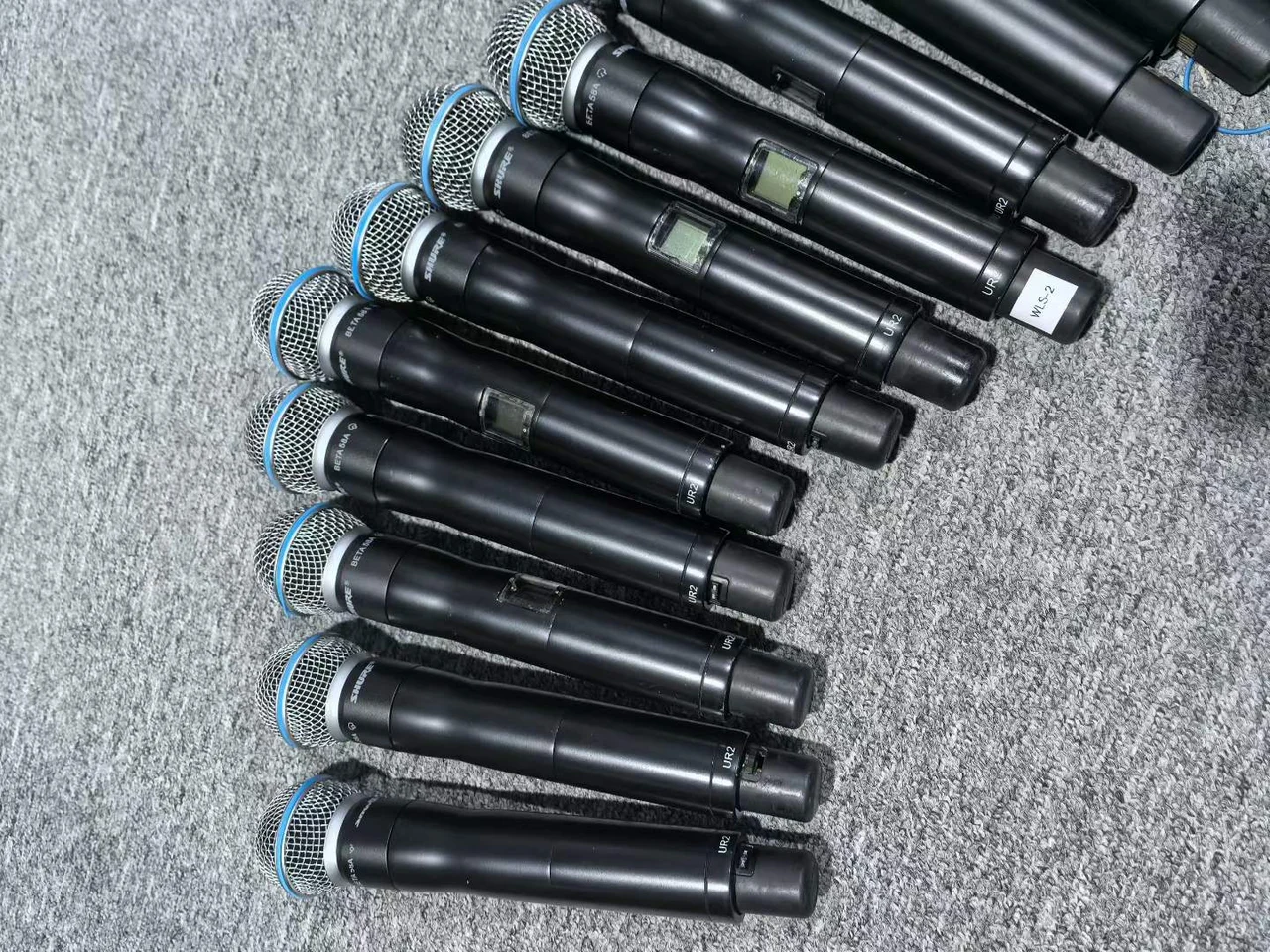 Supplied photograph of Shure UHF-R handheld components; identity and availability require confirmation — photograph 1