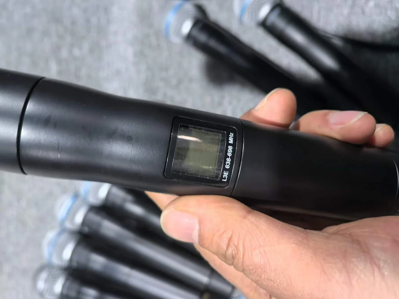 Supplied photograph of Shure UHF-R handheld components; identity and availability require confirmation — photograph 4