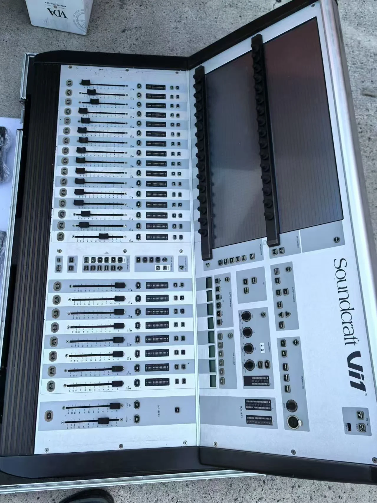 Supplied photograph showing a Soundcraft Vi1-labelled console in a case — photograph 1
